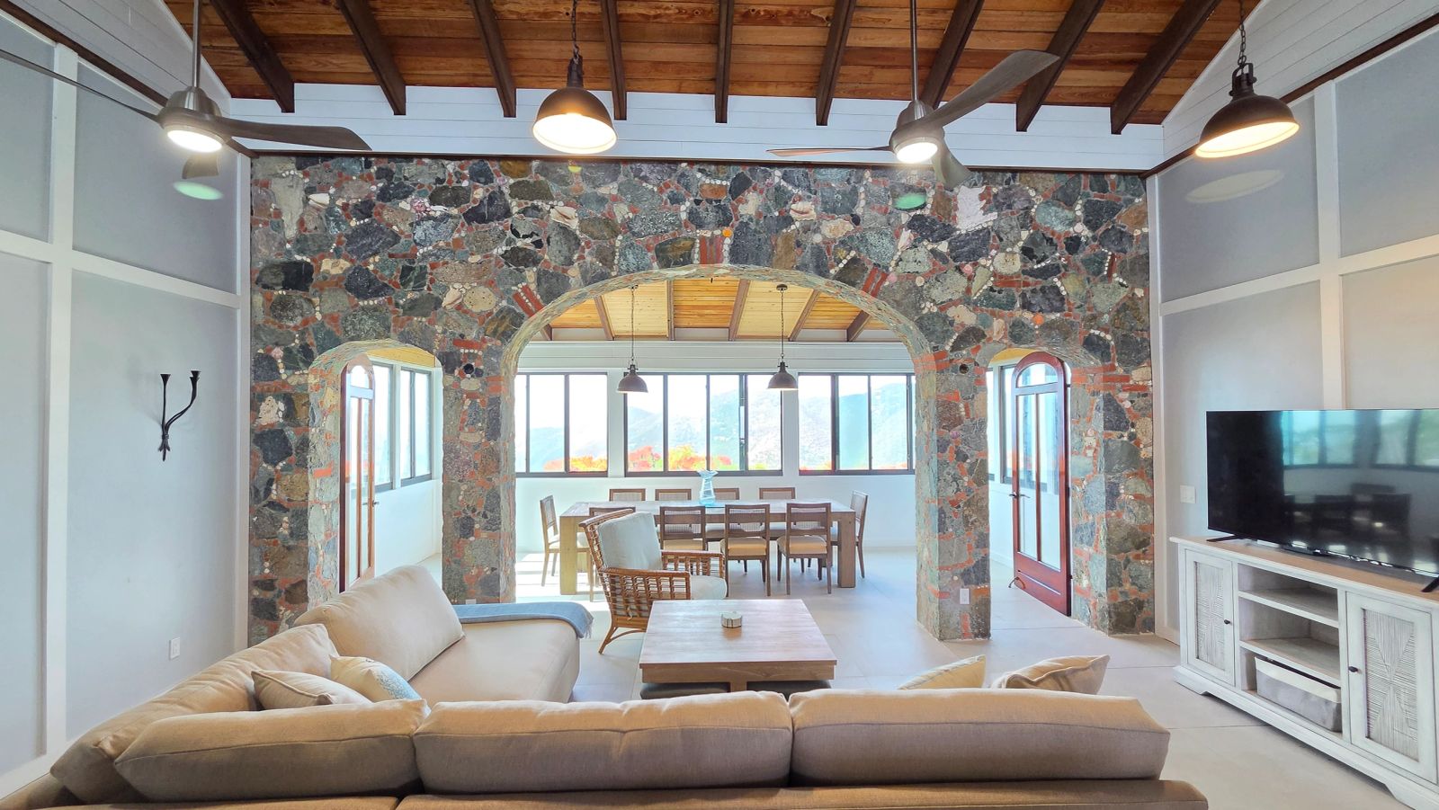 Bright living and dining room with stone arches at Beyond A Dream